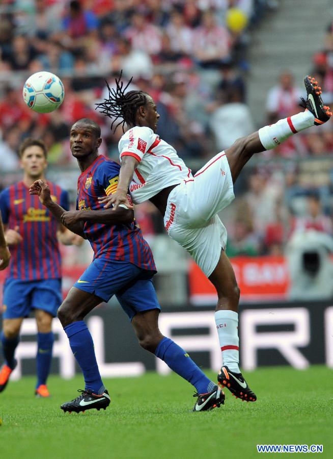 Barcelona's Eric Abidal (L) fights for the ball during their Audi Cup football match against Internacional de Porto Alegre in Munich, southern Germany, on July 26, 2011. Barcelona won 4-2 on a penalty shoot-out, after a 2-2 draw. (Xinhua/Ma Ning) 