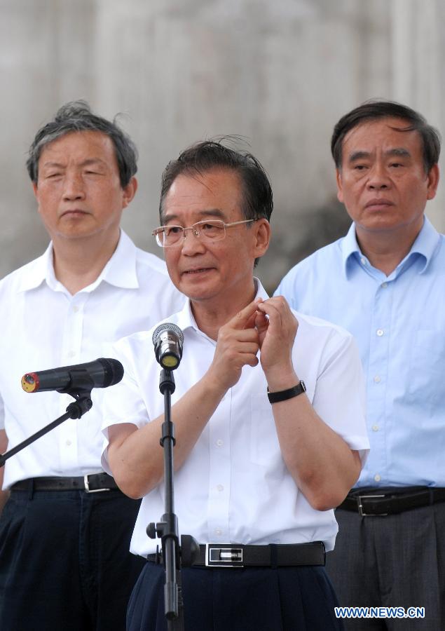 Chinese Premier Wen Jiabao meets the press at the site of the fatal train crash in Wenzhou, east China's Zhejiang Province, July 28, 2011.