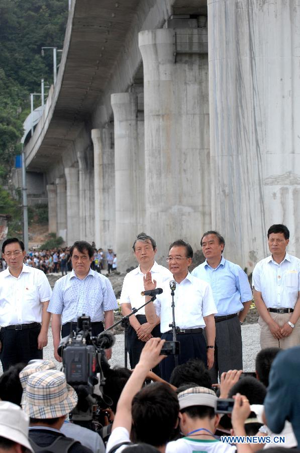 Chinese Premier Wen Jiabao meets the press at the site of the fatal train crash in Wenzhou, east China's Zhejiang Province, July 28, 2011. 