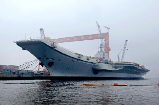 The undated photo shows the imported aircraft carrier body is refitted. China's Defense Ministry said on Wednesday that the country is making use of an imported aircraft carrier body for refitting to be used for scientific research, experiment and training.[Photo/Xinhua]