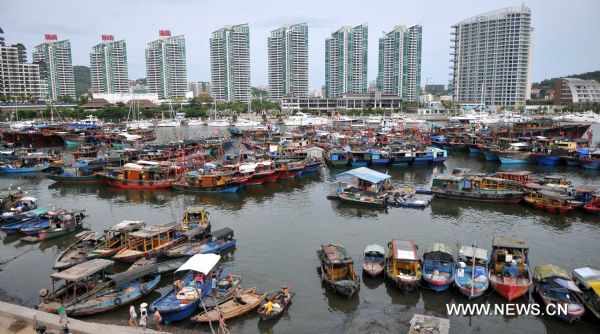 Fishing boats are seen anchored at a harbor in Sanya, south China's Hainan Province, July 28, 2011. [Xinhua] 