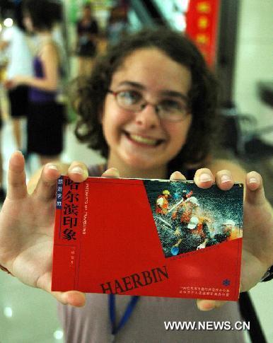 An American exchange student displays a post card she bought in the Harbin No. 1 Middle School in Harbin, capital of northeast China's Heilongjiang Province, July 28, 2011. Twenty middle school students from the United States began their exchange studies at the school Thursday. 