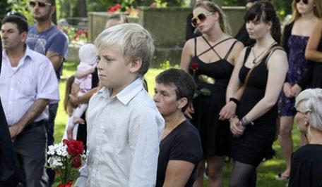 People attend the funeral ceremony of Bano Rashid, 18, at Nesodden church near Oslo July 29, 2011, as the nation pauses for memorial services after the worst attacks on the nation since World War Two. [REUTERS/Wolfgang Rattay]