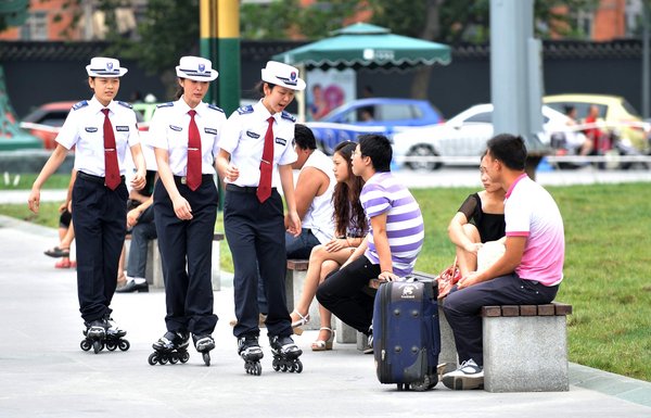 Female chengguan, wearing roller blades, perform duties at Tianfu Square in downtown Chengdu, southwest China's Sichuan province, Aug 1, 2011. [Photo/CFP] 