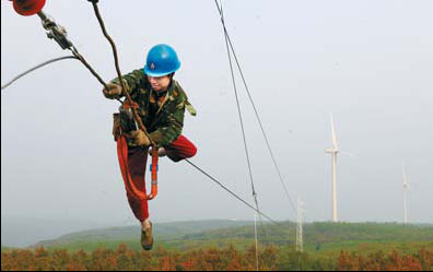 A worker connects power cables to a wind farm in Laian, Anhui province. The authorities will inspect wind-power facilities this month after technical failures were reported. 