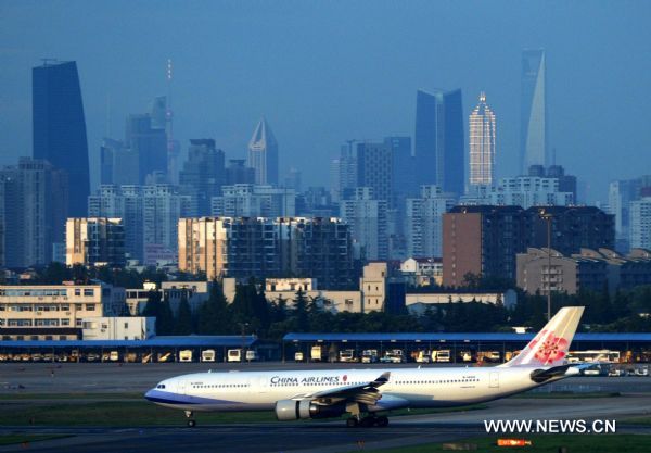 A plane is seen on a runway of Shanghai Hongqiao Airport in Shanghai, east China, Aug. 7, 2011. Shanghai Hongqiao Airport resumed normal operation on Sunday after the influence of the typhoon Muifa. (Xinhua/Niu Yixin)(mcg) 