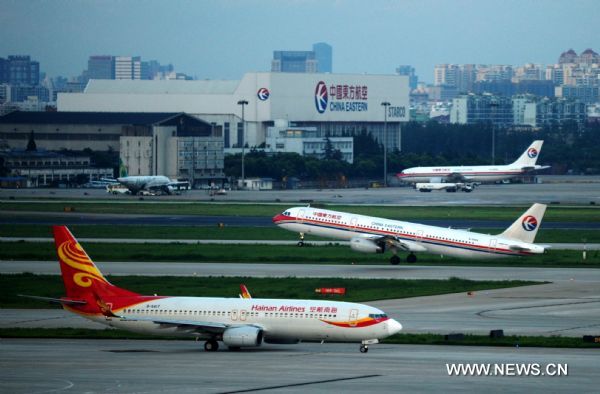 A plane takes off at Shanghai Hongqiao Airport in Shanghai, east China, Aug. 7, 2011. Shanghai Hongqiao Airport resumed normal operation on Sunday after the influence of the typhoon Muifa. (Xinhua/Niu Yixin)(mcg) 