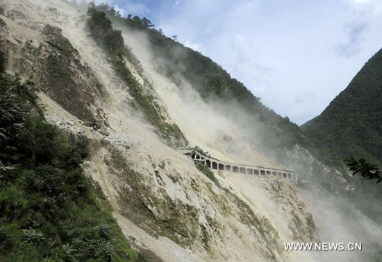 Photo taken on Aug. 7, 2011 shows the landslide site near Moxi Township, southwest China&apos;s Sichuan Province. A landslide occured near Moxi Township Saturday night, causing the interruption of the road linking Hailuogou scenic zone and Luding County of Sichuan Province. [Xinhua]