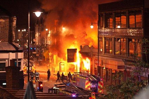Buildings burn on Tottenham High Road, London after youths protested against the killing of a man by armed police in an attempted arrest, August 6, 2011 in London, England. Twenty-nine-year-old father-of-four Mark Duggan died August 4 after being shot by police in Tottenham, north London. 