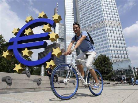 A cyclist rides past the European Central Bank (ECB) headquarters in Frankfurt, August 4, 2011. The ECB is demanding that Italian Prime Minister Silvio Berlusconi commit to fast-track specific welfare reforms and a constitutional amendment enshrining a fiscal rule before it will buy Italian bonds.