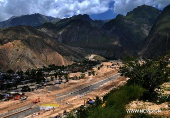 Photo taken on Aug. 7, 2011 shows the Sanyanyu diversion channel which is under construction in Zhouqu of northwest China's Gansu Province.