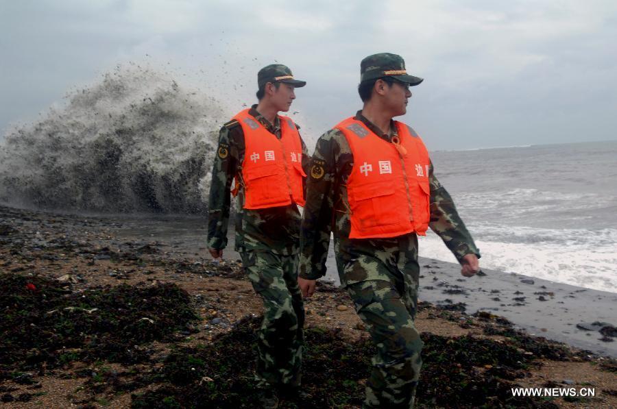 Soldiers of Chinese border guard check a seashore in Dalian, a coastal city in northeast China's Liaoning Province, as the Typhoon Muifa approaches the coast of the province on Aug. 8, 2011. [Xinhua]