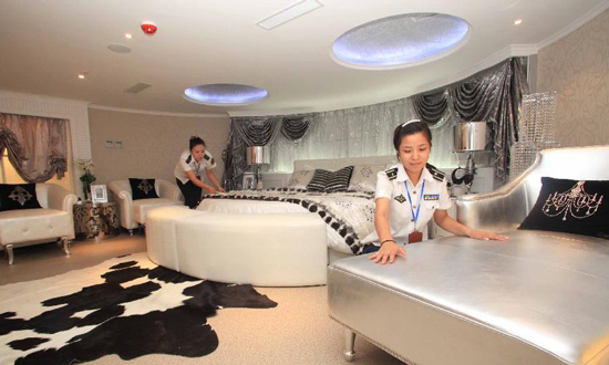 The photo, taken on August 8, shows two attendants tidying up the Presidential Suite of a hotel on 'Kiev', a retired aircraft carrier of the former Soviet Union purchased by a Chinese company in 2000. The Carrier Kiev has now been converted into a military theme park. Photo: Xinhua
