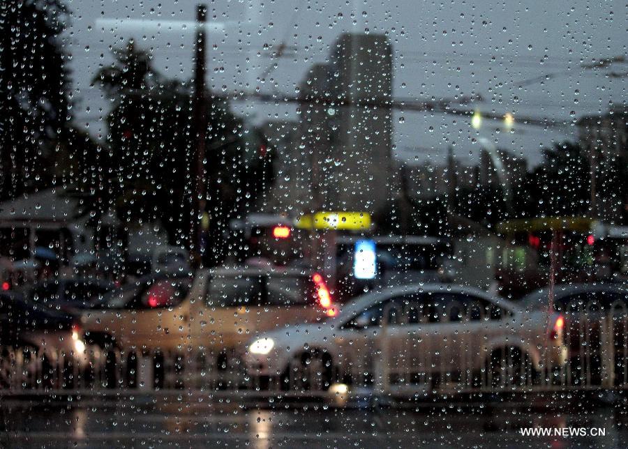 Photo taken through a car window on Aug. 9, 2011 shows vehicles moving in the rain in Beijing, capital of China. Beijing was hit by a heavy rainfall Tuesday. [Xinhua]