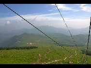 Lingshan Mountain is crowned as the highest mountain on the outskirts of Beijing. The top of the mountain is covered with snow all year round. It has the typical landform of a plateau with gentle slopes. As a matter of fact, July and early August are the spring time for Lingshan, when meadows thrive with green grass and languid white sheep wander across the meadow. It is also surprising to see mountain yaks which are known as the 'boat of the plateau' there. [妞妞她爸/bbs.fengniao]