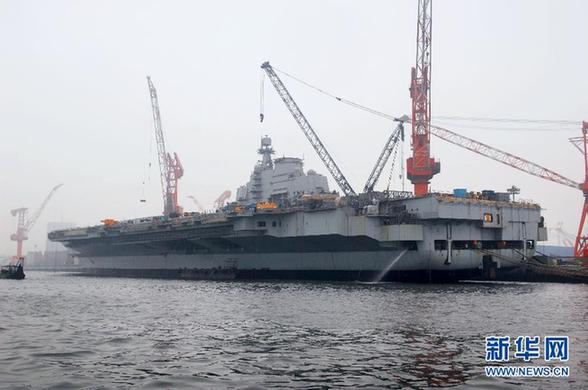 File photo of China's refitted aircraft carrier. The aircraft carrier left its shipyard at Dalian Port in northeast Liaoning Province on Wednesday morning to start its first sea trial. Military sources said that the first sea trial was in line with schedual of the carrier's refitting project and would not take a long time. After returning from the sea trial, the aircraft carrier will continue refit and test work. 