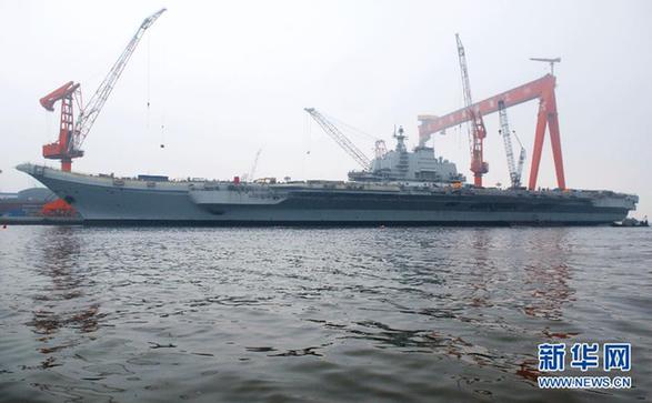 File photo of China's refitted aircraft carrier. The aircraft carrier left its shipyard at Dalian Port in northeast Liaoning Province on Wednesday morning to start its first sea trial. Military sources said that the first sea trial was in line with schedual of the carrier's refitting project and would not take a long time. After returning from the sea trial, the aircraft carrier will continue refit and test work. 