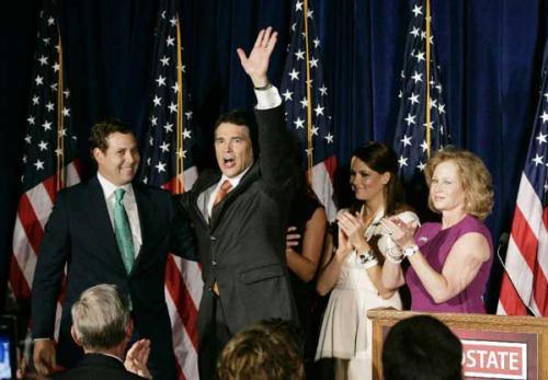 Texas Gov. Rick Perry (2ndL) waves to the audience with his family after announcing he will run for the Republican presidential nomination in Charleston, South Carolina. 