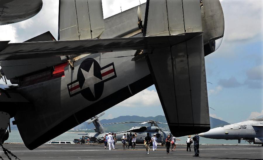 Visitors are seen on the deck of the USS Ronald Reagan Aircraft Carrier in Hong Kong, Aug. 13, 2011. The USS Ronald Reagan Aircraft Carrier and its three support ships arrived in Hong Kong on Friday for a four-day port visit, which is its fourth visit here. [Chen Xiaowei/Xinhua]