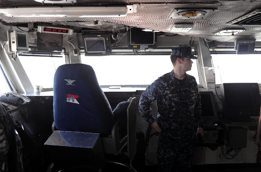 A soldier stands beside the captain's chair on the USS Ronald Reagan Aircraft Carrier in Hong Kong, Aug. 13, 2011. The USS Ronald Reagan Aircraft Carrier and its three support ships arrived in Hong Kong on Friday for a four-day port visit, which is its fourth visit here. [Chen Xiaowei/Xinhua]