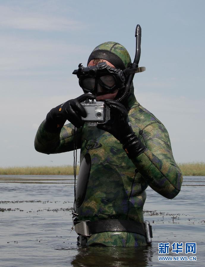 Russian Prime Minister Putin prepares to dive with an underwater camera in the river Volga in Russia's Astrakhan region August 16, 2011. 