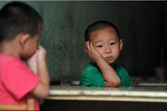 Two boys worry about their schooling for the coming semester in Beijing on August 15, 2011. Their primary school, where most pupils are the children of migrant workers, was demolished on August 10 after the contract between the school and local government ended.