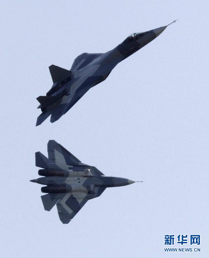 Two Sukhoi T-50 jets fly during a display at the opening of the MAKS International Aviation and Space Salon at Zhukovsky airport outside Moscow August 17, 2011. The T-50, a joint project between Russia and India, made its first public flight on Wednesday.