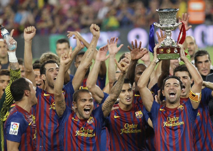 Barcelona's captain Xavi Hernandez (R) holds the trophy as he celebrates with teammates their victory against Real Madrid in their Spanish Supercup second leg soccer match at the Camp Nou stadium in Barcelona August 17, 2011. (Xinhua/Reuters Photo)