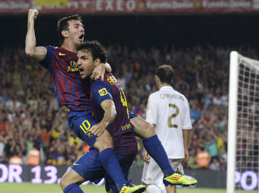 Barcelona's Lionel Messi (L) and Cesc Fabregas celebrate a goal against Real Madrid at Camp Nou stadium in Barcelona August 17, 2011. (Xinhua/Reuters Photo) 