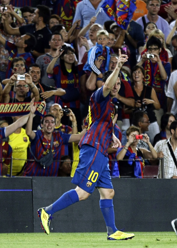 Barcelona's Lionel Messi celebrates his goal against Real Madrid goalkeeper Iker Casillas during their Spanish Supercup second leg soccer match at Nou Camp stadium in Barcelona August 17, 2011. (Xinhua/Reuters Photo)