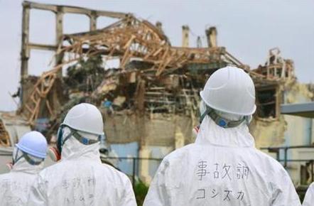Picture taken by the investigation panel on June 17, 2011 shows Members of the Japanese government panel to investigate the accident at Fukushima nuclear power plant, inspect the damaged building housing the No.3 reactor at the Tokyo Electric Power Company (TEPCO)'s Fukushima Dai-ichi nuclear power plant in Fukushima prefecture.