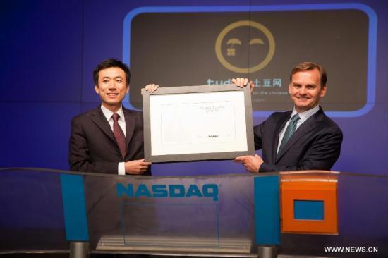 Photo provided by Nasdaq shows Gary Wang (L), CEO of Tudou, China's second-largest online video site Tudou Holdings Ltd., attending a ceremony at Nasdaq, New York, Aug. 17, 2011. Tudou on Wednesday issued shares on Nasdaq Stock Market, just one week after the markets underwent a huge turbulence following the downgrade of U.S. credit rating. 