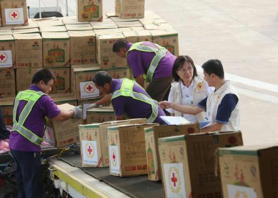 Workers help load relief materials for Libya onto a plane at an airport in Tianjin, August 17, 2011.