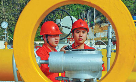 Workers examine natural gas equipment in Enshi, Hubei province. China's natural gas production rose 9.8 percent year-on-year to 8.2 billion cubic meters in July. 
