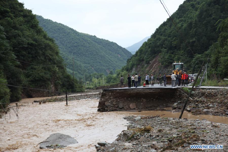 Photo taken on Aug. 18, 2011 shows damaged road in Huixian County, northwest China's Gansu Province. A flood hit the county Wednesday night, leaving 120 houses collapsed and 842 houses damaged. [Xinhua]