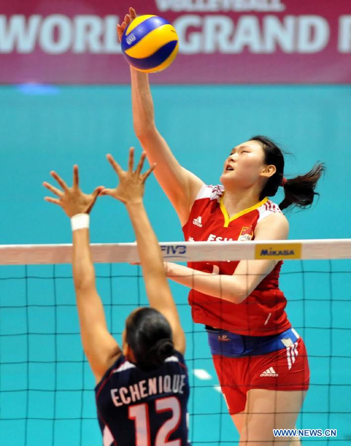 Wang Yimei (R) of China spikes the ball during the Group I match of the women's World Grand Prix Hong Kong session between China and Dominica at Hong Kong Coliseum in Hong Kong, south China, Aug. 19, 2011. China won 3-0. [Xinhua]