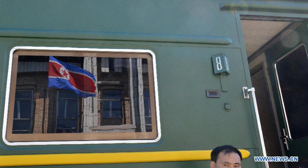 A North Korean national flag is reflected in a coach window of the train of North Korean leader Kim following its arrival at Khasan station after crossing the border between North Korea and Russia, near Russia's far eastern city of Vladivostok August 20, 2011. North Korean leader Kim Jong-il arrived in Russia on a special train on Saturday as the isolated state tries to reach out to regional powers and seek economic aid. 