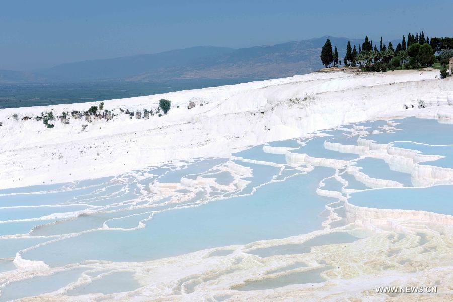 Pamukkale, meaning 'cotton castle' in Turkish, is a natural site in Denizli Province in southwestern Turkey and contains hot springs and travertines, terraces of carbonate minerals left by the flowing water. It is in total about 2,700 meters long, 600 meters wide and 160 meters high. Pamukkale was recognized as a World Heritage Site in 1988. 