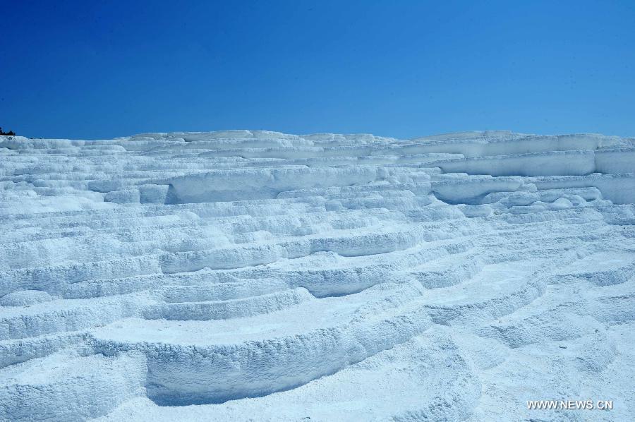 Pamukkale, meaning 'cotton castle' in Turkish, is a natural site in Denizli Province in southwestern Turkey and contains hot springs and travertines, terraces of carbonate minerals left by the flowing water. It is in total about 2,700 meters long, 600 meters wide and 160 meters high. Pamukkale was recognized as a World Heritage Site in 1988. 