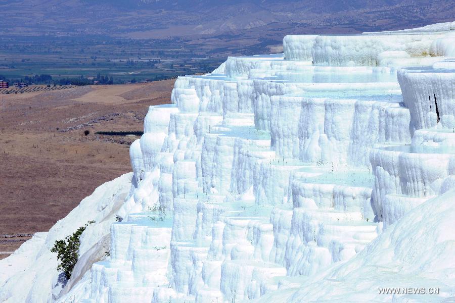 Pamukkale, meaning 'cotton castle' in Turkish, is a natural site in Denizli Province in southwestern Turkey and contains hot springs and travertines, terraces of carbonate minerals left by the flowing water. It is in total about 2,700 meters long, 600 meters wide and 160 meters high. Pamukkale was recognized as a World Heritage Site in 1988. 