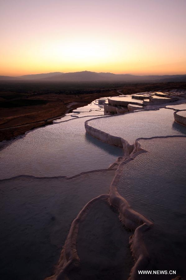 Pamukkale, meaning 'cotton castle' in Turkish, is a natural site in Denizli Province in southwestern Turkey and contains hot springs and travertines, terraces of carbonate minerals left by the flowing water. It is in total about 2,700 meters long, 600 meters wide and 160 meters high. Pamukkale was recognized as a World Heritage Site in 1988. 