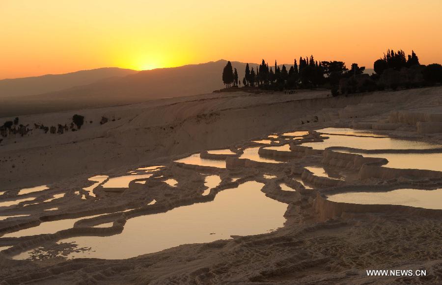 Pamukkale, meaning 'cotton castle' in Turkish, is a natural site in Denizli Province in southwestern Turkey and contains hot springs and travertines, terraces of carbonate minerals left by the flowing water. It is in total about 2,700 meters long, 600 meters wide and 160 meters high. Pamukkale was recognized as a World Heritage Site in 1988. 