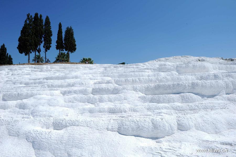 Pamukkale, meaning 'cotton castle' in Turkish, is a natural site in Denizli Province in southwestern Turkey and contains hot springs and travertines, terraces of carbonate minerals left by the flowing water. It is in total about 2,700 meters long, 600 meters wide and 160 meters high. Pamukkale was recognized as a World Heritage Site in 1988. 