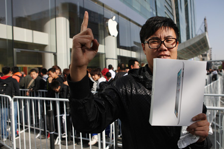 The first buyer of an iPad 2 holds up his device at an Apple flagship store at Xidan in Beijing, May 6. Apple's iPad 2 went on sale on the Chinese mainland on May 6. [Photo / Xinhua] 