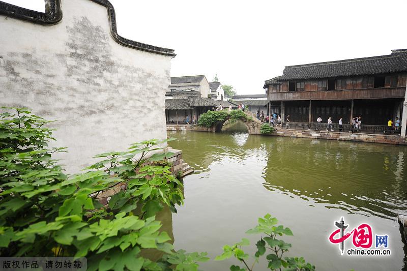 With a history of 1,200-year, Wuzhen is about one hour's drive from Hangzhou,the capital of Zhejiang Province.The small town is famous for the ancient buildings and old town layout, where bridges of all sizes cross the streams winding through the town. [China.org.cn]