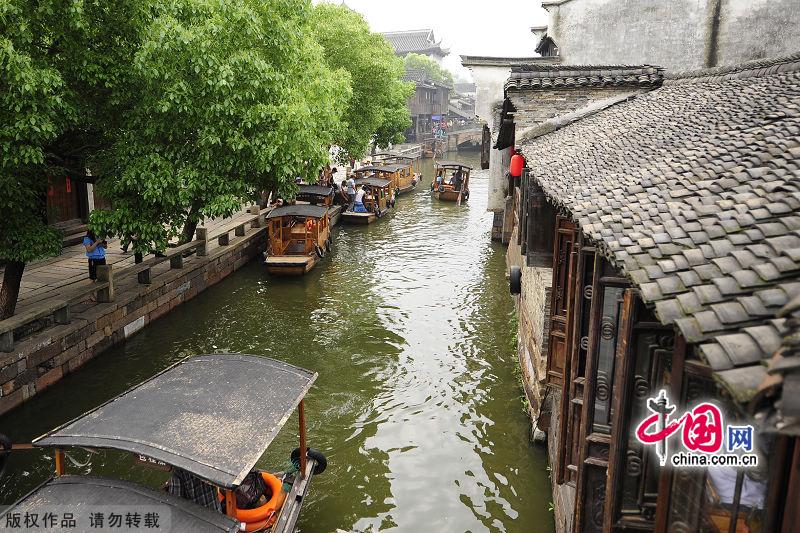 With a history of 1,200-year, Wuzhen is about one hour's drive from Hangzhou,the capital of Zhejiang Province.The small town is famous for the ancient buildings and old town layout, where bridges of all sizes cross the streams winding through the town. [China.org.cn]