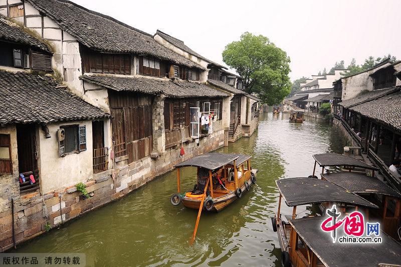 With a history of 1,200-year, Wuzhen is about one hour's drive from Hangzhou,the capital of Zhejiang Province.The small town is famous for the ancient buildings and old town layout, where bridges of all sizes cross the streams winding through the town. [China.org.cn]