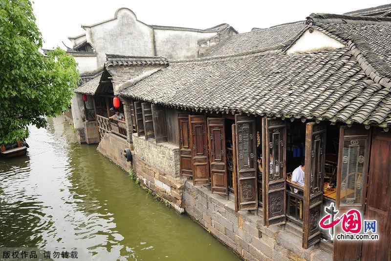 With a history of 1,200-year, Wuzhen is about one hour's drive from Hangzhou,the capital of Zhejiang Province.The small town is famous for the ancient buildings and old town layout, where bridges of all sizes cross the streams winding through the town. [China.org.cn]