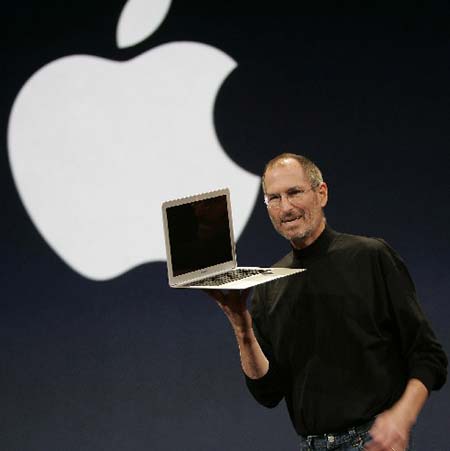 Apple CEO Steve Jobs holds up the new Macbook Air during his keynote speech at the MacWorld Conference & Expo in San Francisco, California. (Xinhua/AFP Photo)