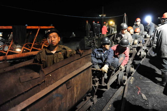 Miners prepare to enter a flooded coal pit to rescue trapped workers in a coal mine in Qitaihe city, Northeast China's Heilongjiang province, August 23, 2011. The pit was flooded while 45 miners were working in it.